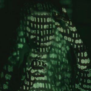 An unrecognizable person with binary code projected, symbolizing cybersecurity and digital coding.